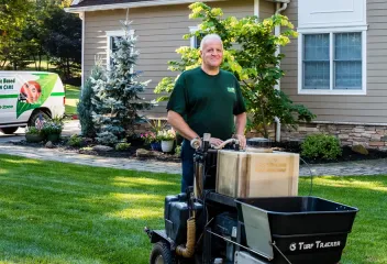 lawn technician fertilizing lawn