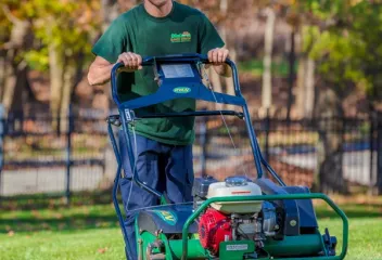 lawn technician aerating lawn